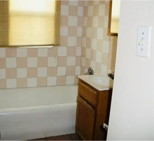 a bathroom with a toilet a sink and bathtub