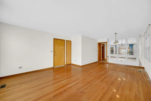 a view of a kitchen with wooden floor and a sink