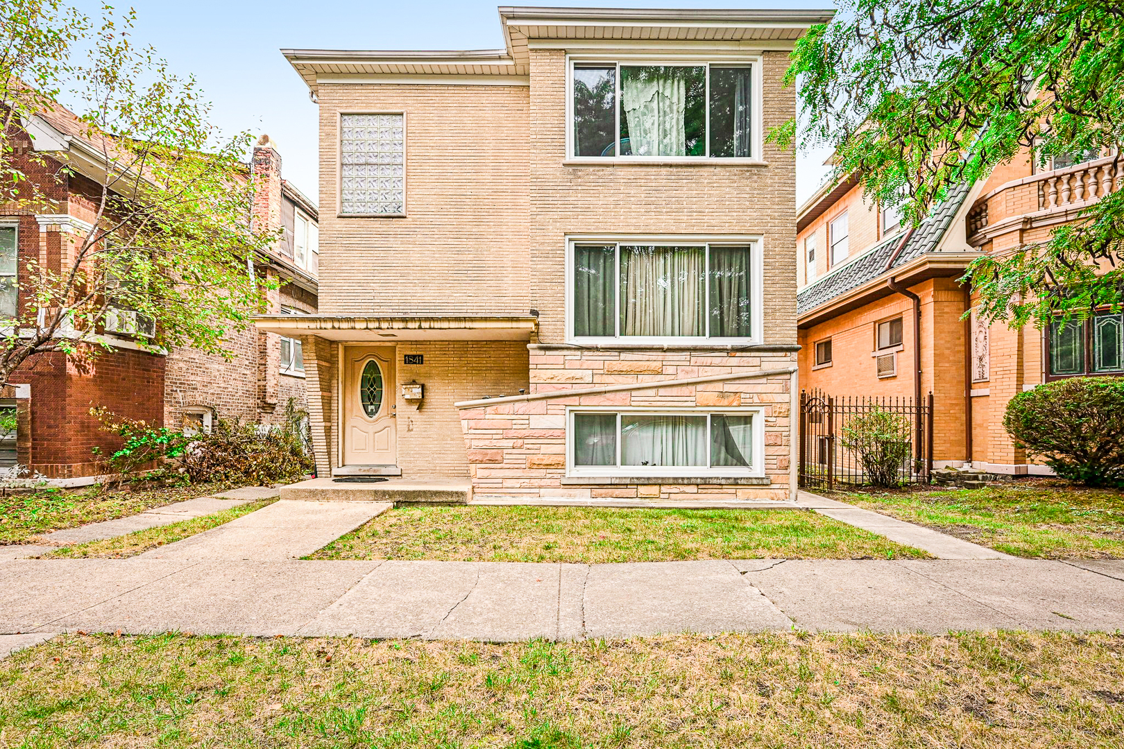 1841 South 61st Court Cicero, IL 60804 - Photo 1 of 46 a view of a brick house with many windows and a yard