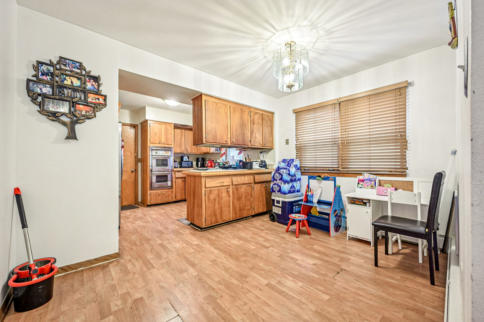 1841 South 61st Court Cicero, IL 60804 - Photo 12 of 46 a room with furniture a chandelier and a view of kitchen