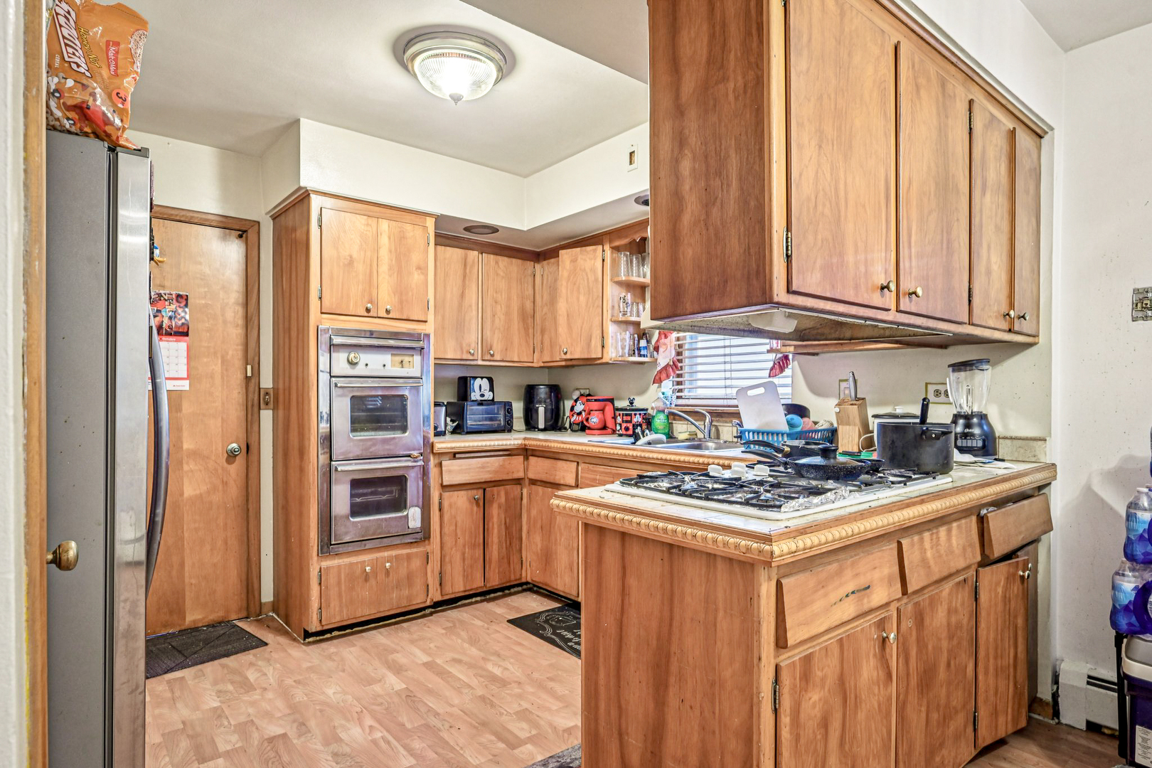 1841 South 61st Court Cicero, IL 60804 - Photo 13 of 46 a kitchen with stainless steel appliances granite countertop a stove top oven a refrigerator a sink and dishwasher with white cabinets