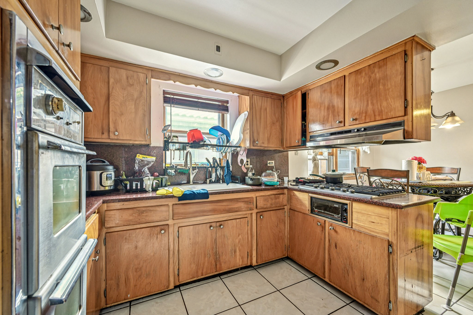 1841 South 61st Court Cicero, IL 60804 - Photo 17 of 46 a kitchen with a sink stove and cabinets