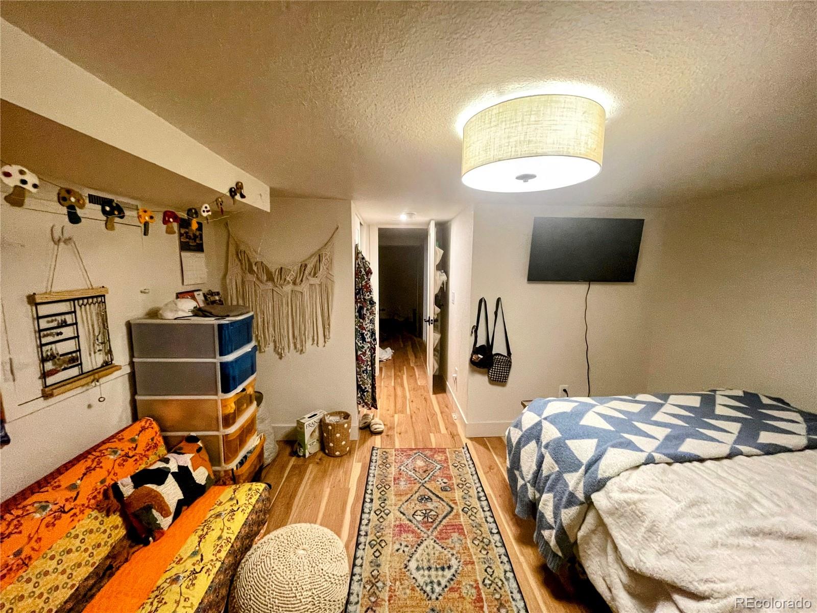 1069 11th Street Boulder, CO 80302 - Photo 11 of 28 a bedroom with bed and a mirror