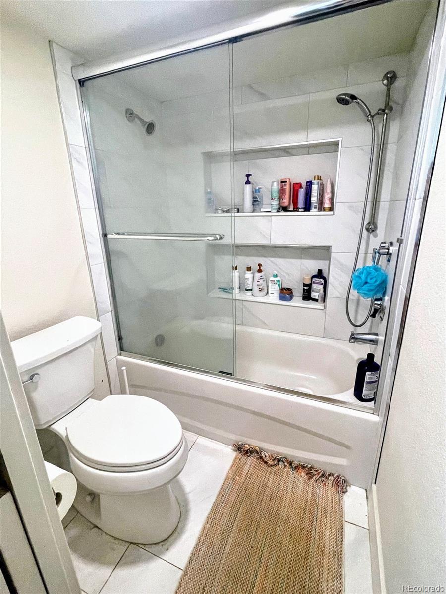 1069 11th Street Boulder, CO 80302 - Photo 14 of 28 a bathroom with a toilet and a shower