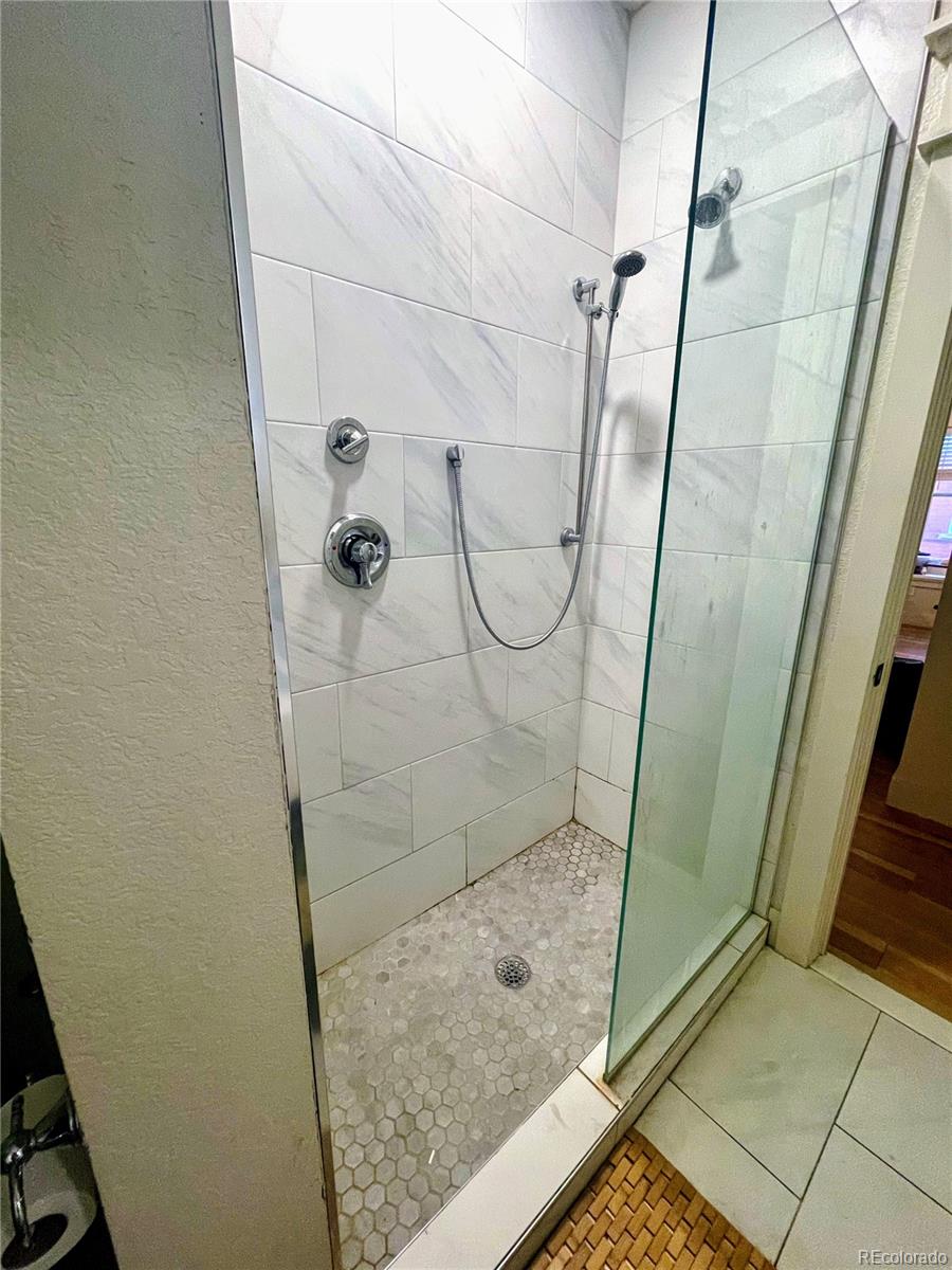 1069 11th Street Boulder, CO 80302 - Photo 16 of 28 a bathroom with a glass shower door