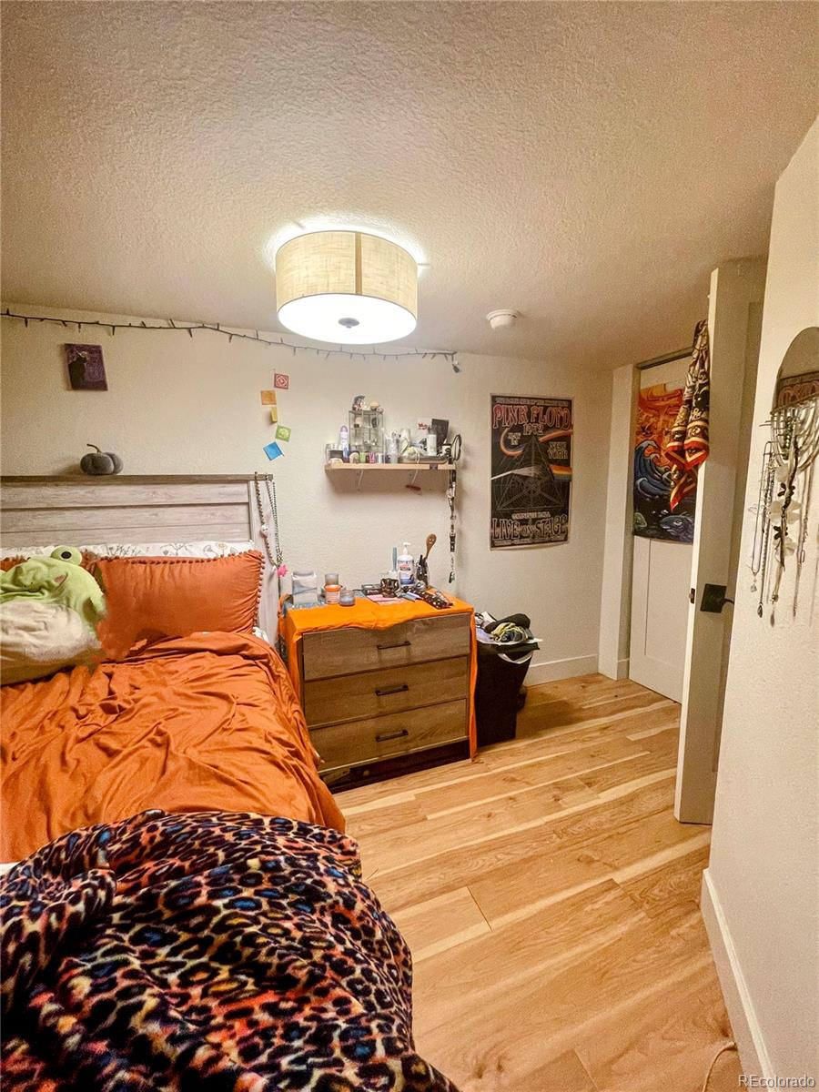 1069 11th Street Boulder, CO 80302 - Photo 17 of 28 a bedroom with a large bed and a chandelier