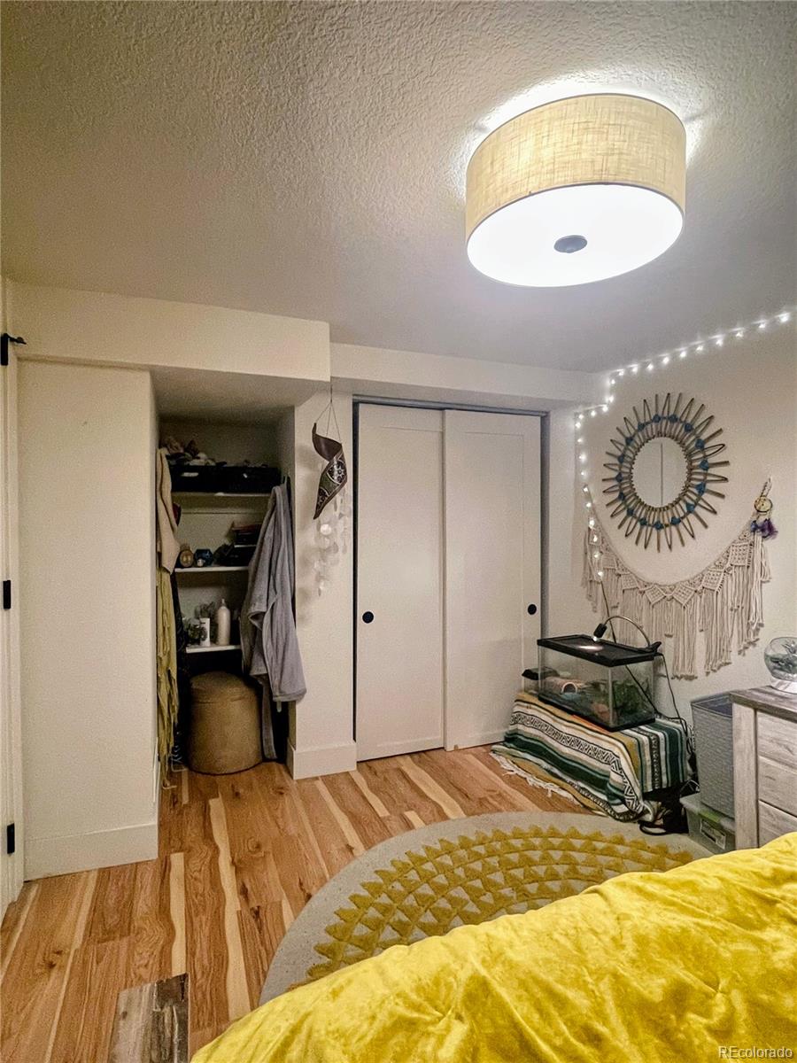 1069 11th Street Boulder, CO 80302 - Photo 18 of 28 a bedroom with a bed and a chandelier