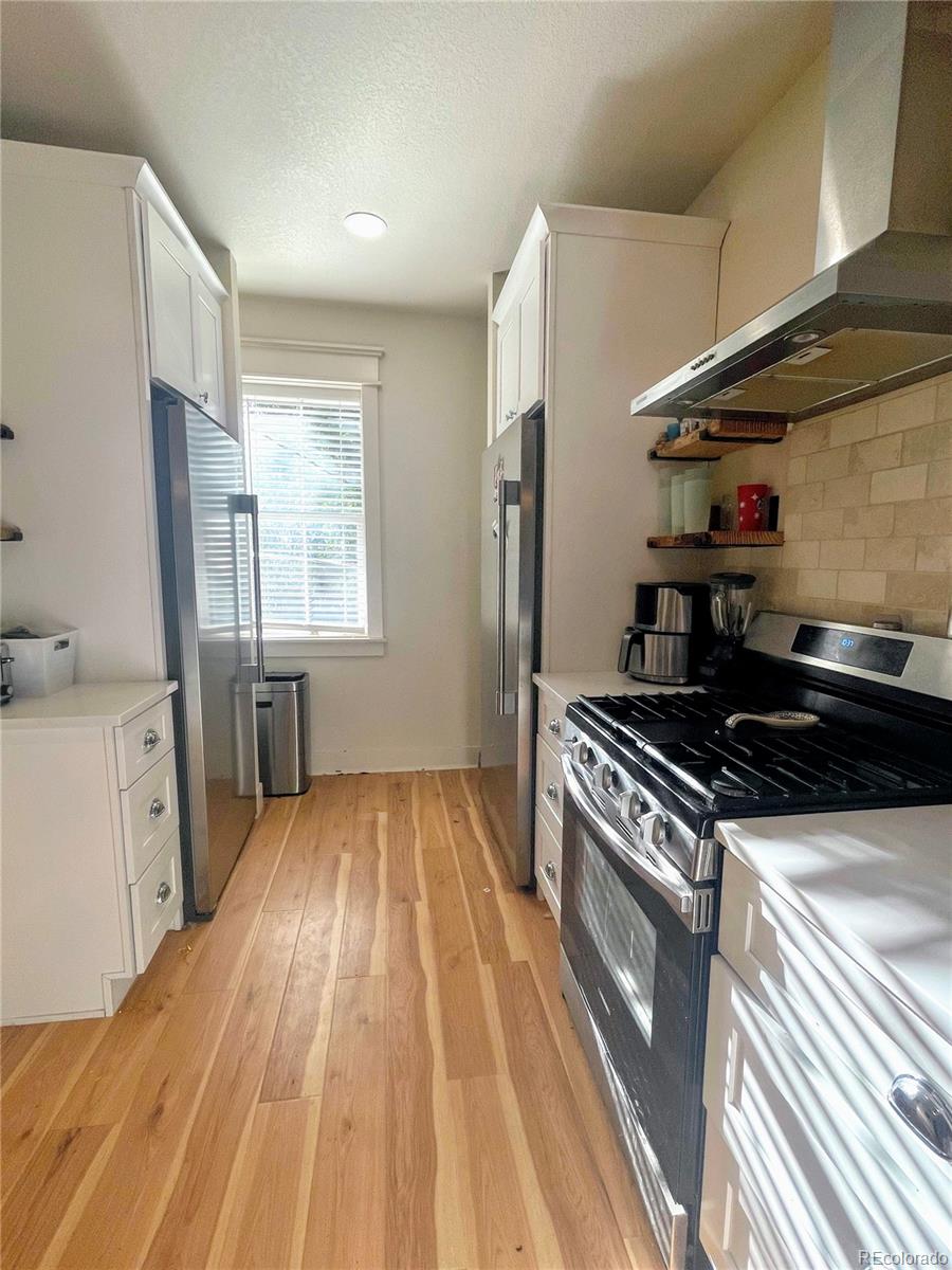 1069 11th Street Boulder, CO 80302 - Photo 4 of 28 a kitchen with granite countertop a stove and a sink