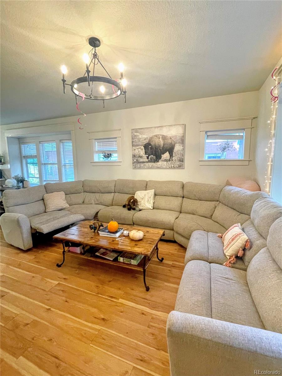 1069 11th Street Boulder, CO 80302 - Photo 7 of 28 a living room with furniture wooden floor and chandelier