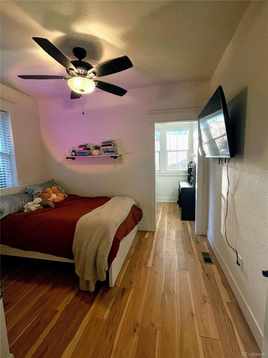 1069 11th Street Boulder, CO 80302 - Photo 8 of 28 a bedroom with a bed and a flat screen tv