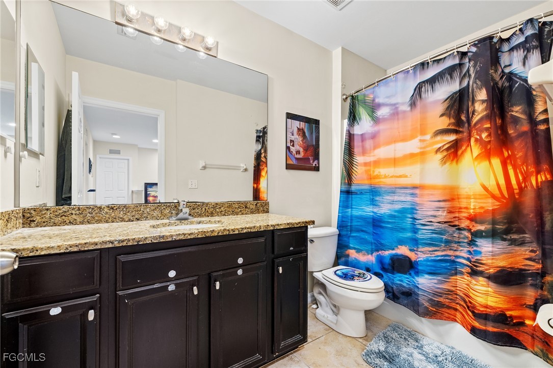 8657 Sumner Avenue Fort Myers, FL 33908 - Photo 20 of 29 a bathroom with a granite countertop double vanity sink mirror and toilet