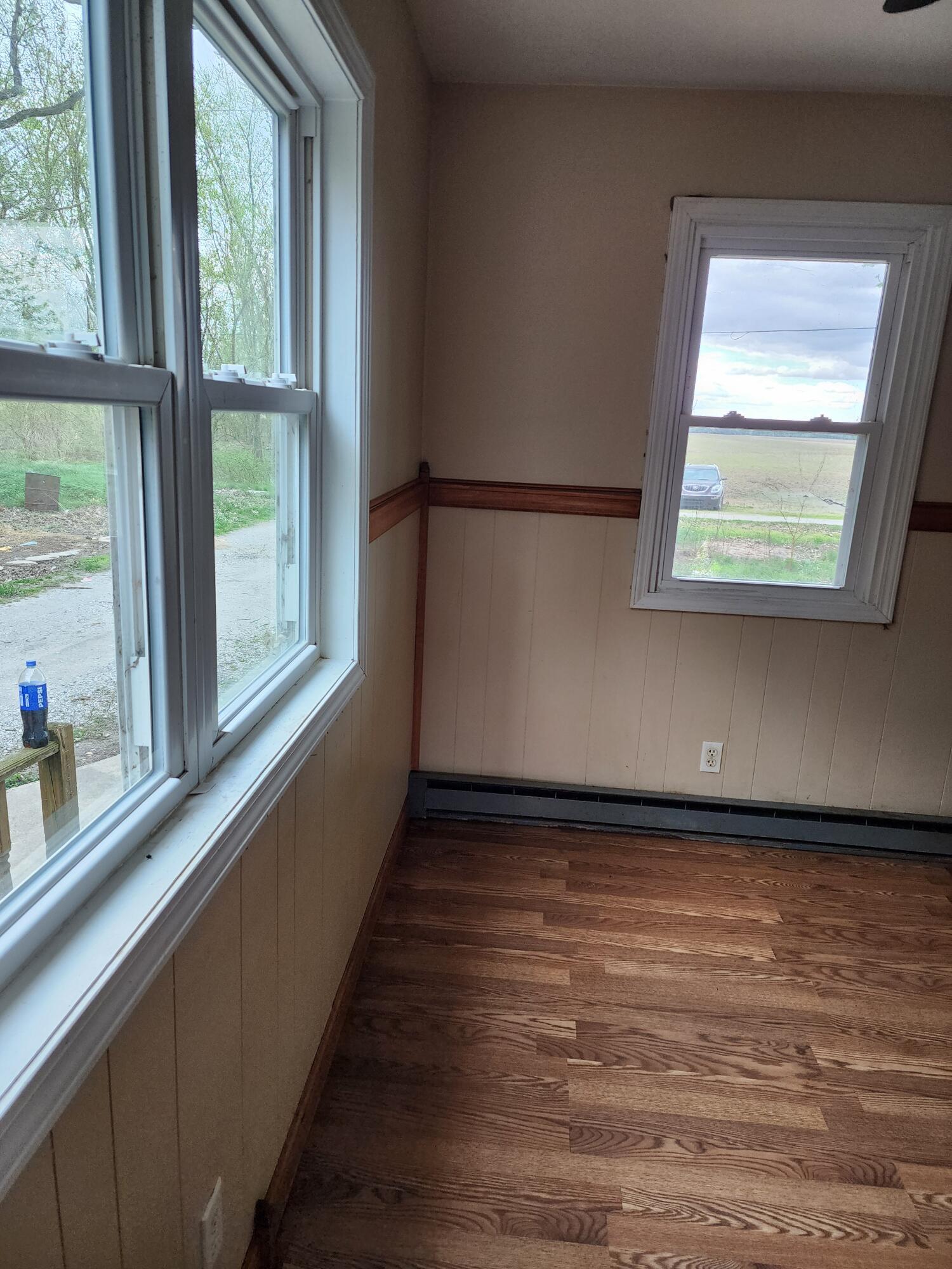 2965 Bunkum Road Rensselaer, IN 47978 - Photo 8 of 39 a view of an empty room with wooden floor and a window