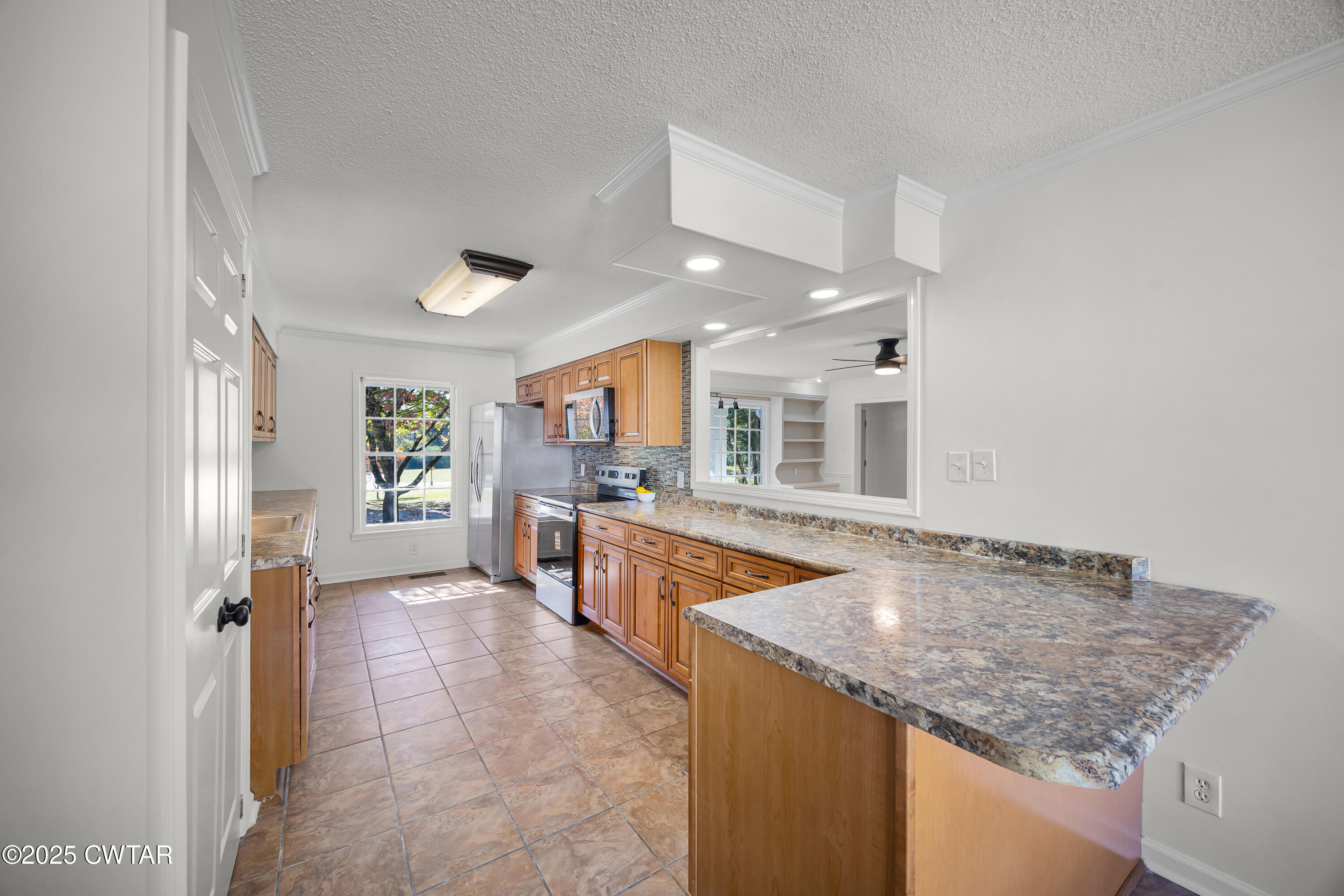 247 Highway 412 Jackson, TN 38305 - Photo 11 of 29 a kitchen with granite countertop a stove and a sink