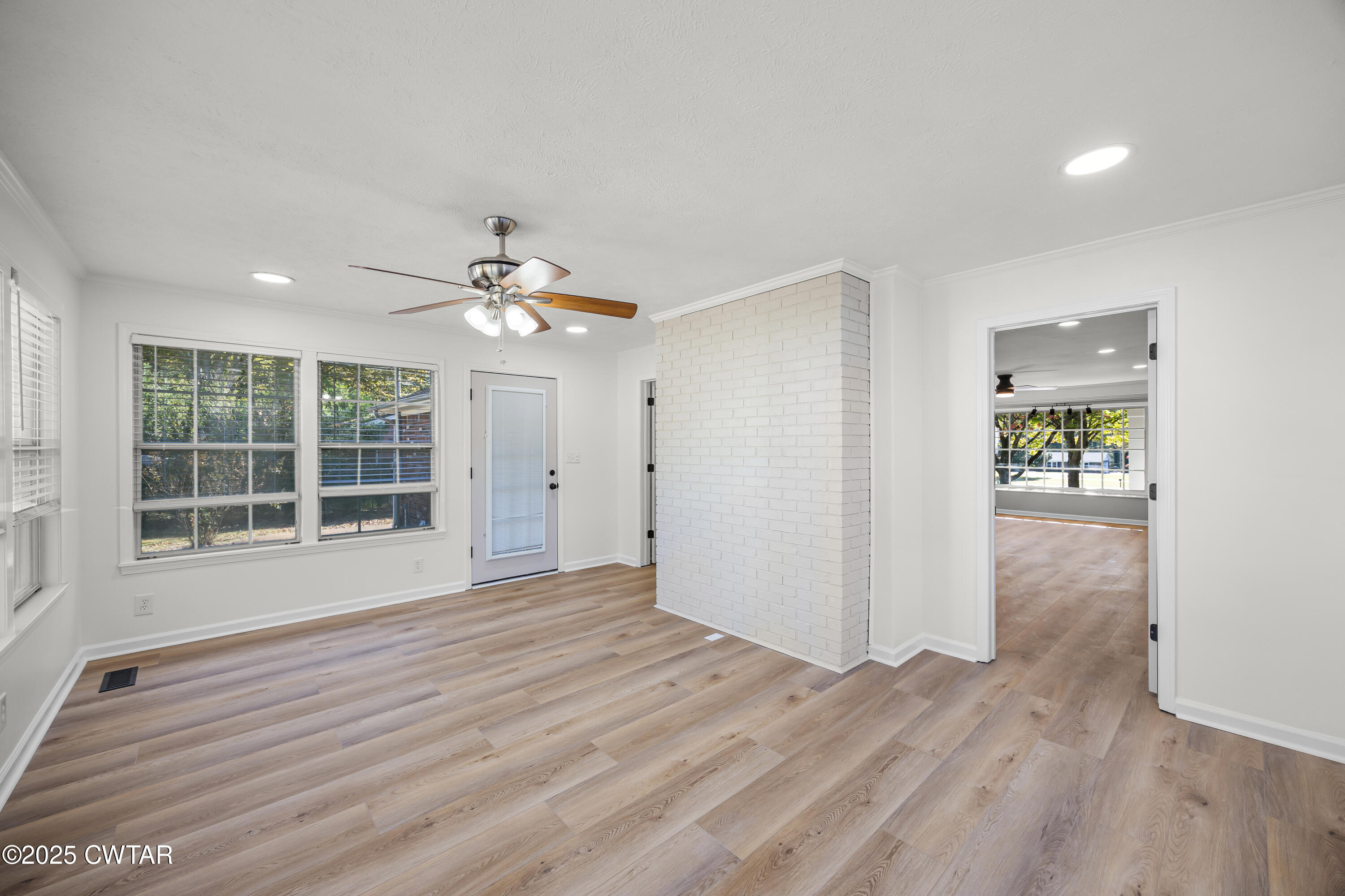 247 Highway 412 Jackson, TN 38305 - Photo 16 of 29 a view of an empty room with wooden floor and a window