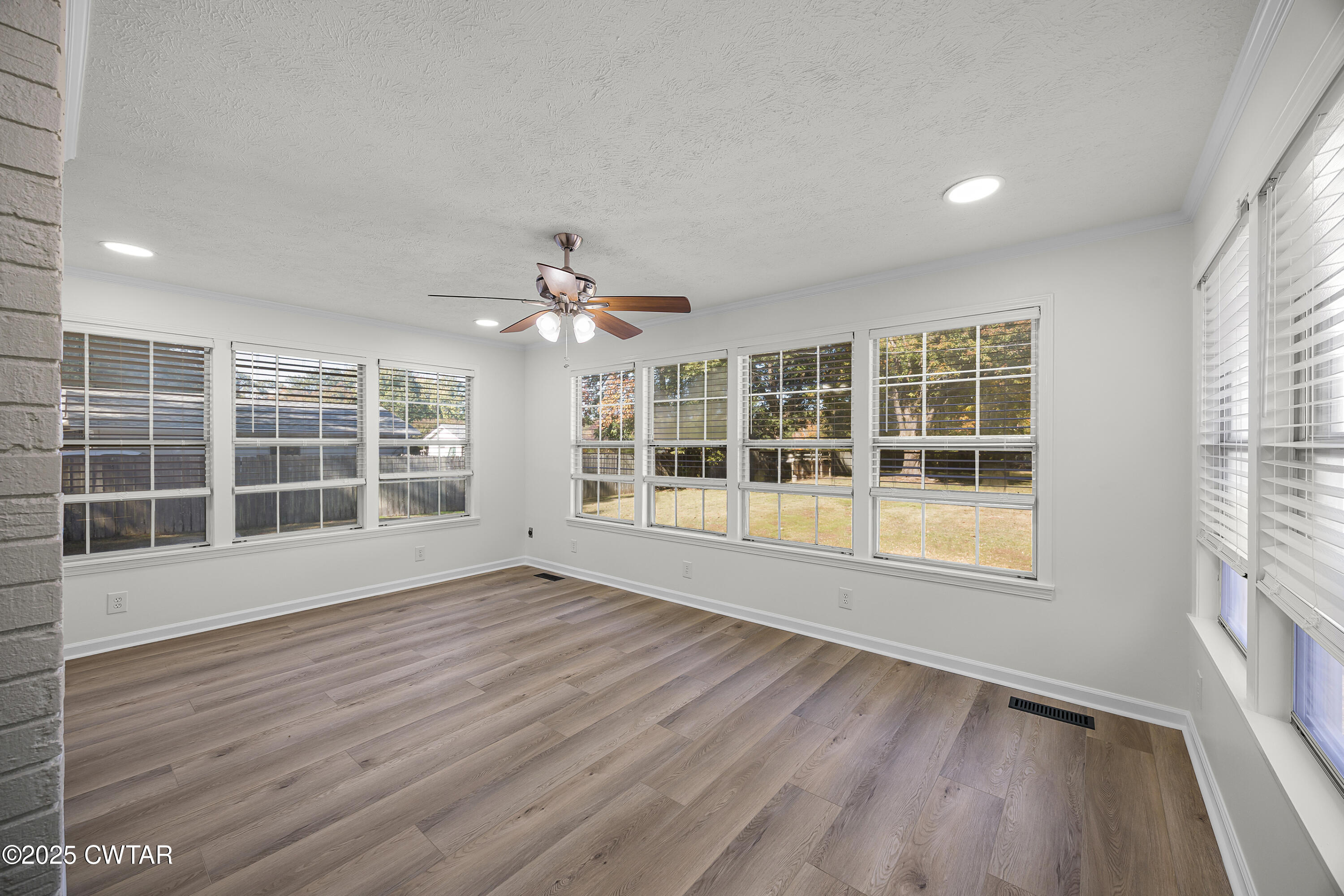 247 Highway 412 Jackson, TN 38305 - Photo 17 of 29 a view of empty room with wooden floor and fan