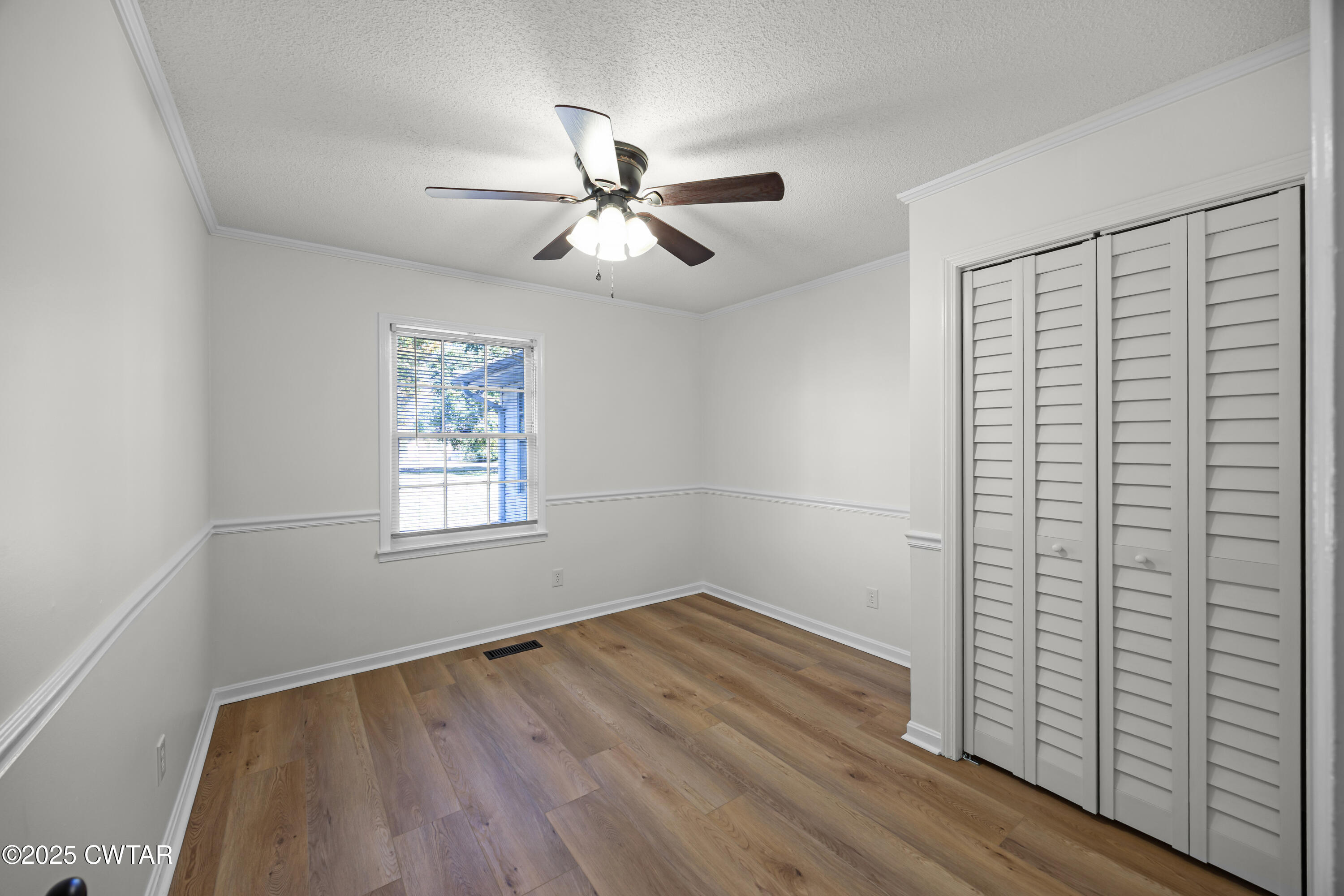 247 Highway 412 Jackson, TN 38305 - Photo 22 of 29 a view of empty room with wooden floor and fan