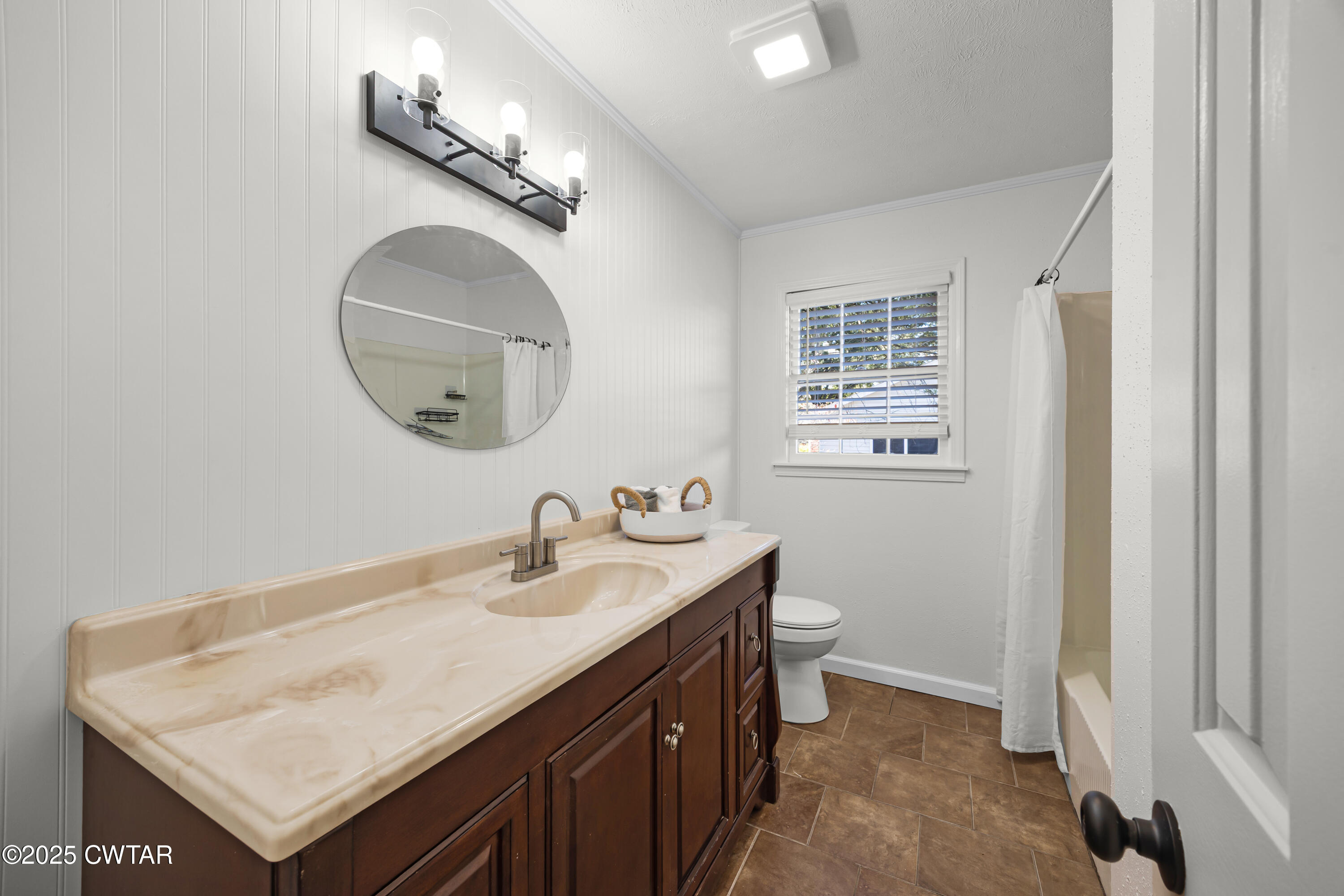 247 Highway 412 Jackson, TN 38305 - Photo 24 of 29 a bathroom with a sink a toilet and a mirror