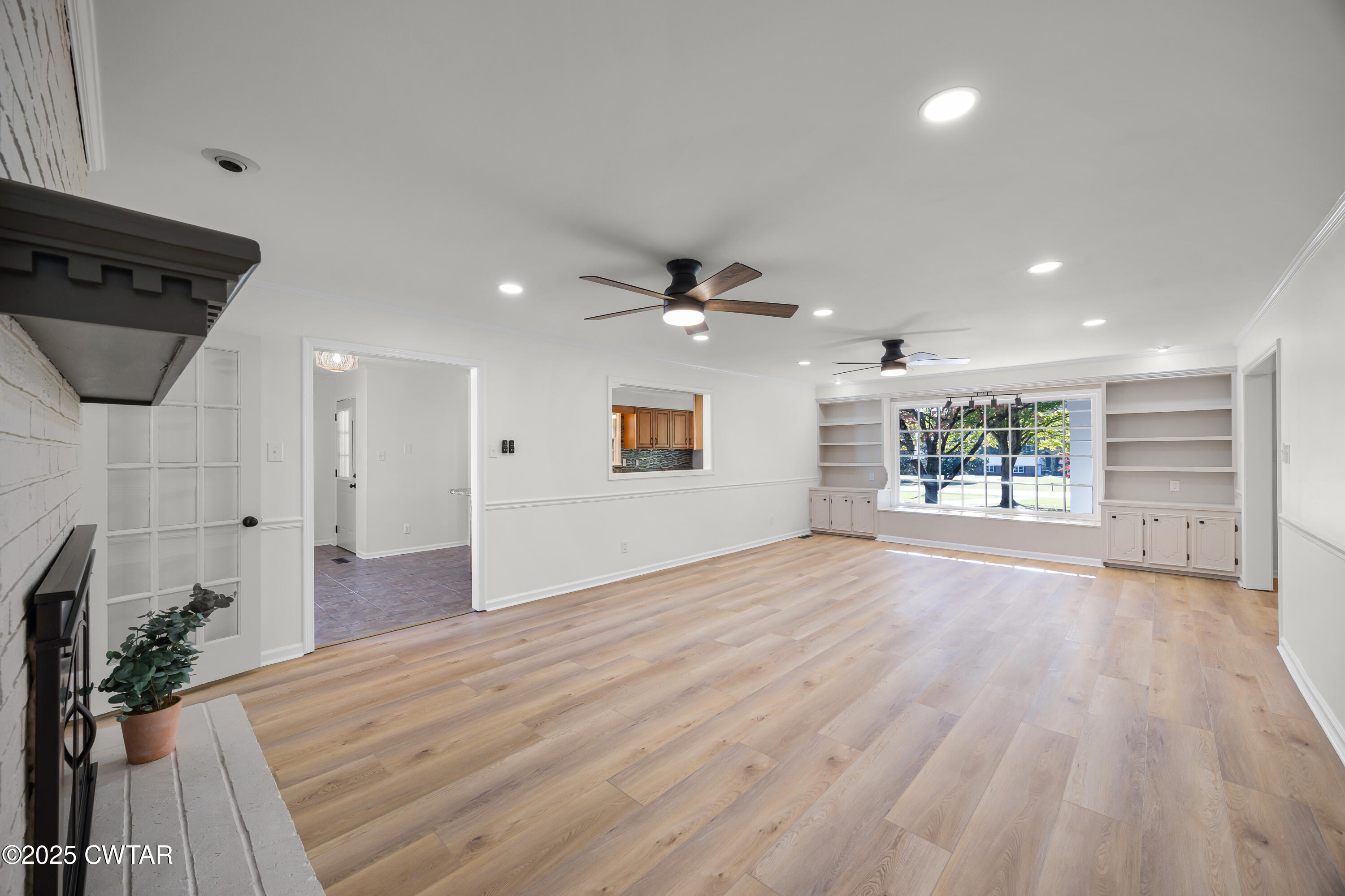 247 Highway 412 Jackson, TN 38305 - Photo 6 of 29 a view of a livingroom with wooden floor and a ceiling fan