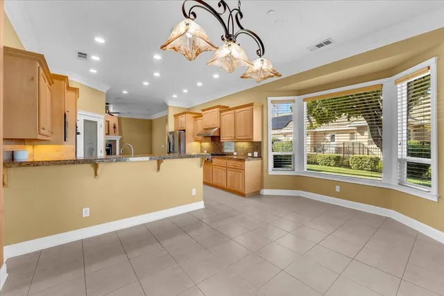 a view of an empty room with a fireplace and a window
