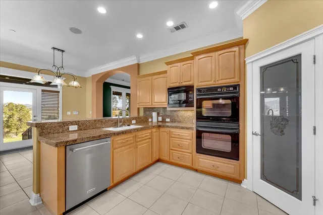 a bathroom with a granite countertop sink toilet mirror and bathtub