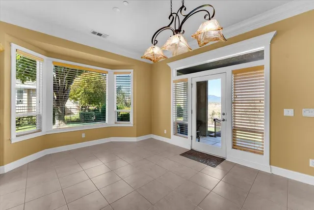 a white bath tub sitting in a bathroom next to a window