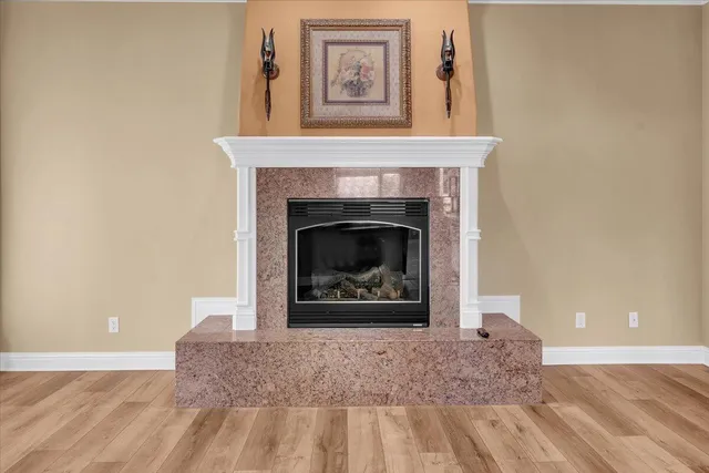 a bedroom with a bed and a flat tv screen on dresser