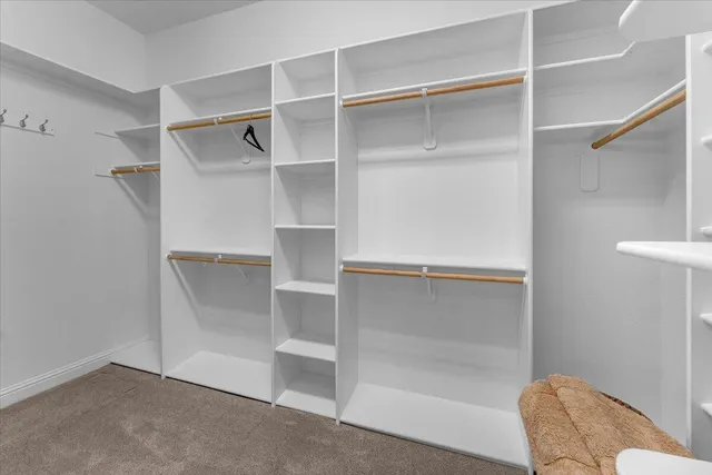 a front view of a house with a yard and potted plants