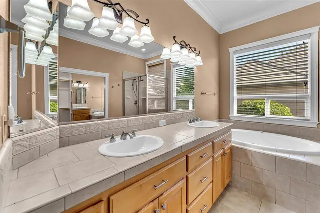 a view of a house with backyard sitting area and a garden