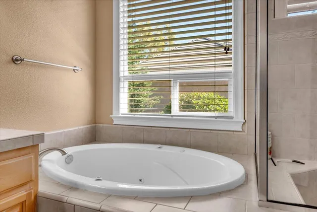a view of a patio with wooden floor next to a yard