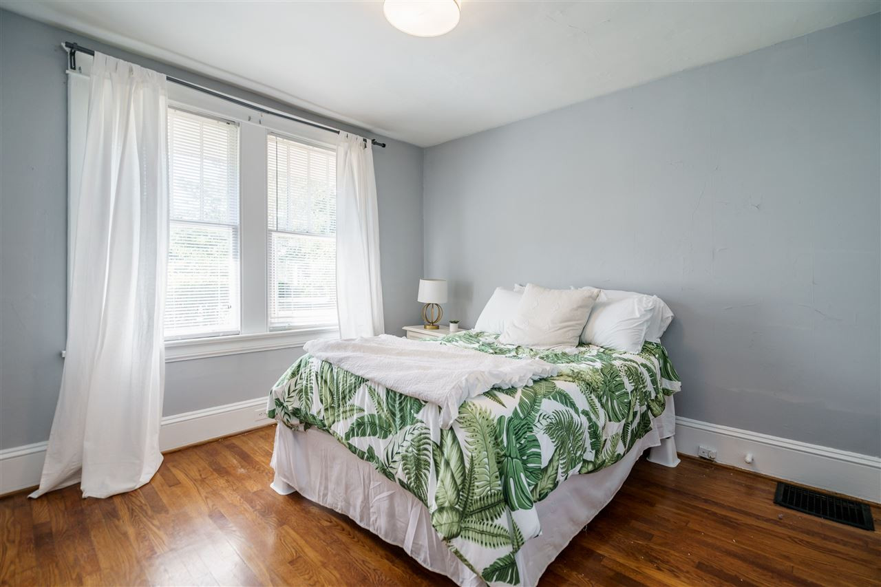 2402 Everett Avenue Raleigh, NC 27607 - Photo 12 of 20 a bed sitting in a bedroom next to a window