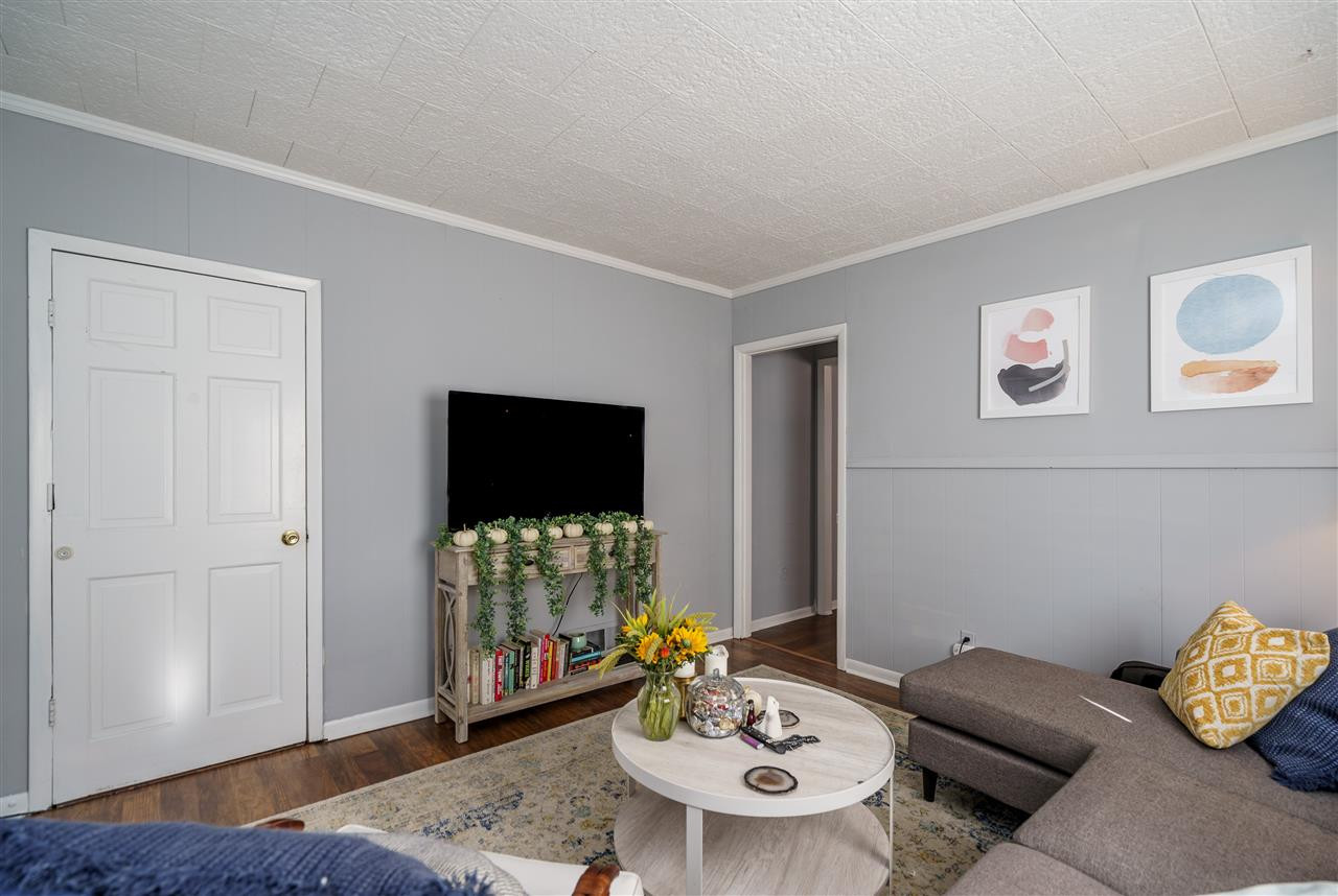 2402 Everett Avenue Raleigh, NC 27607 - Photo 5 of 20 a living room with furniture and a flat screen tv