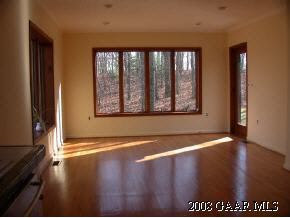 2446 Shutterlee Mill Road Staunton, VA 24401 - Photo 3 of 6 a view of an empty room with wooden floor and a window