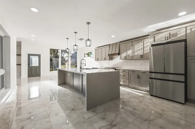 a living room with stainless steel appliances granite countertop furniture and a window