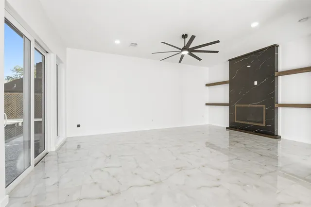 an empty room with closet and windows