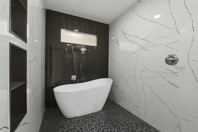 a white bath tub sitting in a bathroom