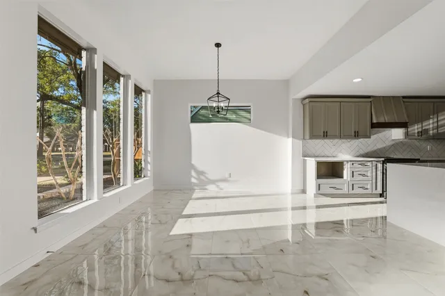 a living room with stainless steel appliances granite countertop furniture and a window