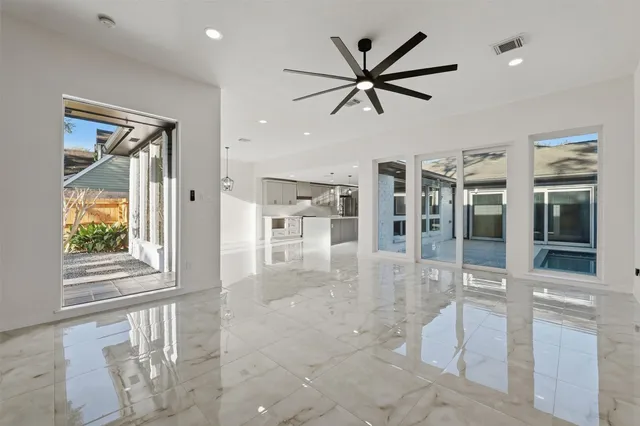 a view of a livingroom with a ceiling fan and window