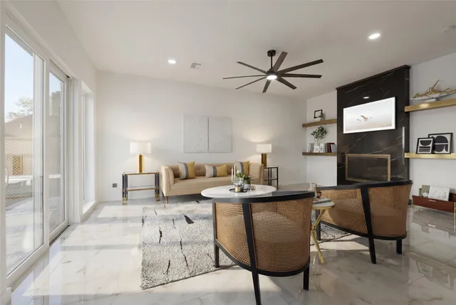 a living room with furniture and a chandelier