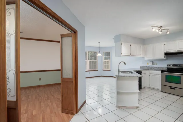 a kitchen with stainless steel appliances granite countertop a refrigerator sink and stove