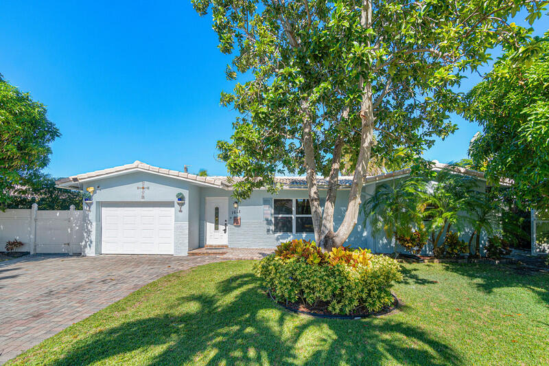 1641 Northwest 9th Street Boca Raton, FL 33486 - Photo 1 of 29 a front view of a house with garden