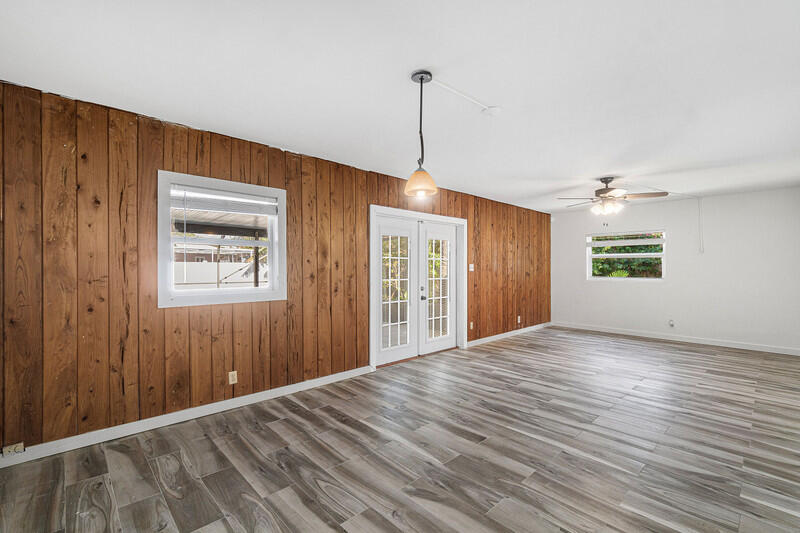 1641 Northwest 9th Street Boca Raton, FL 33486 - Photo 14 of 29 a view of an empty room with wooden floor and a window