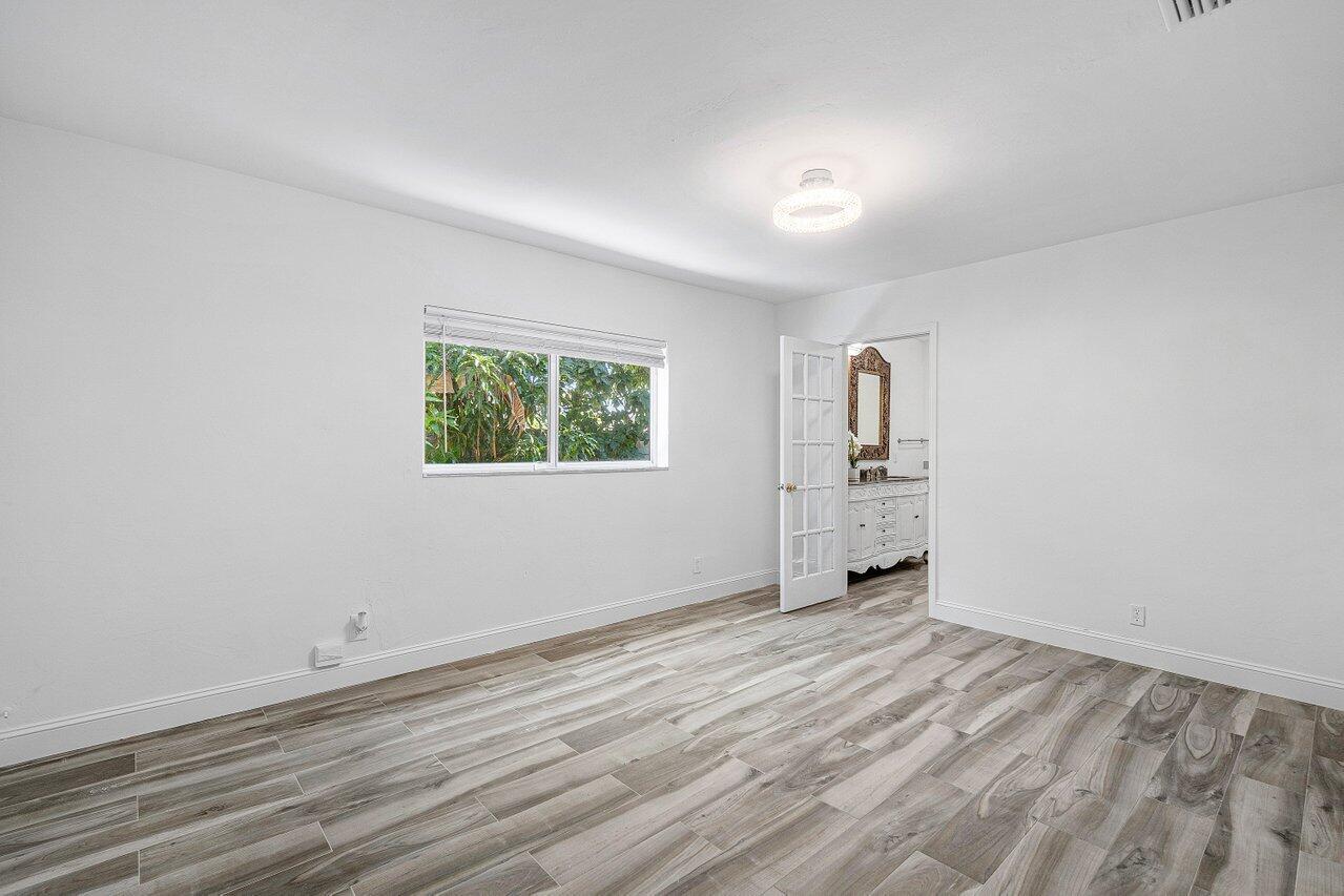 1641 Northwest 9th Street Boca Raton, FL 33486 - Photo 15 of 29 wooden floor in an empty room with a window