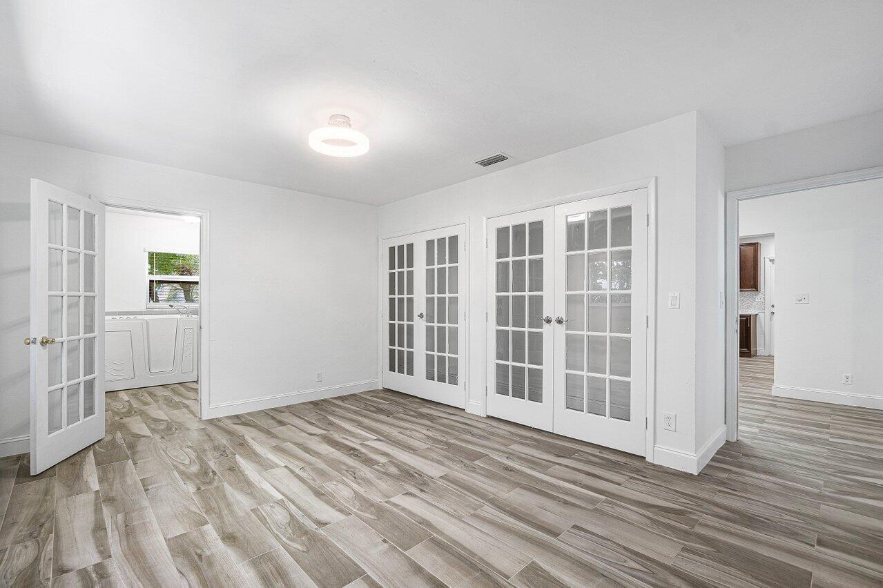 1641 Northwest 9th Street Boca Raton, FL 33486 - Photo 17 of 29 wooden floor in an empty room with a window