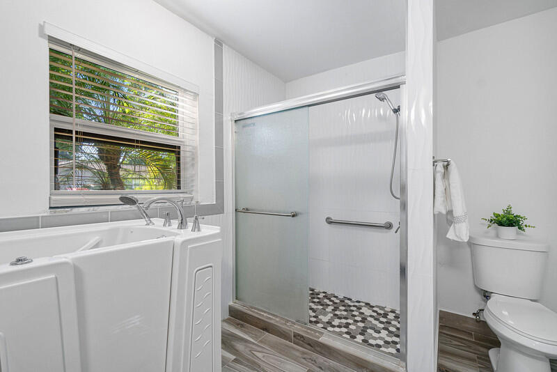 1641 Northwest 9th Street Boca Raton, FL 33486 - Photo 19 of 29 a bathroom with a sink toilet and shower