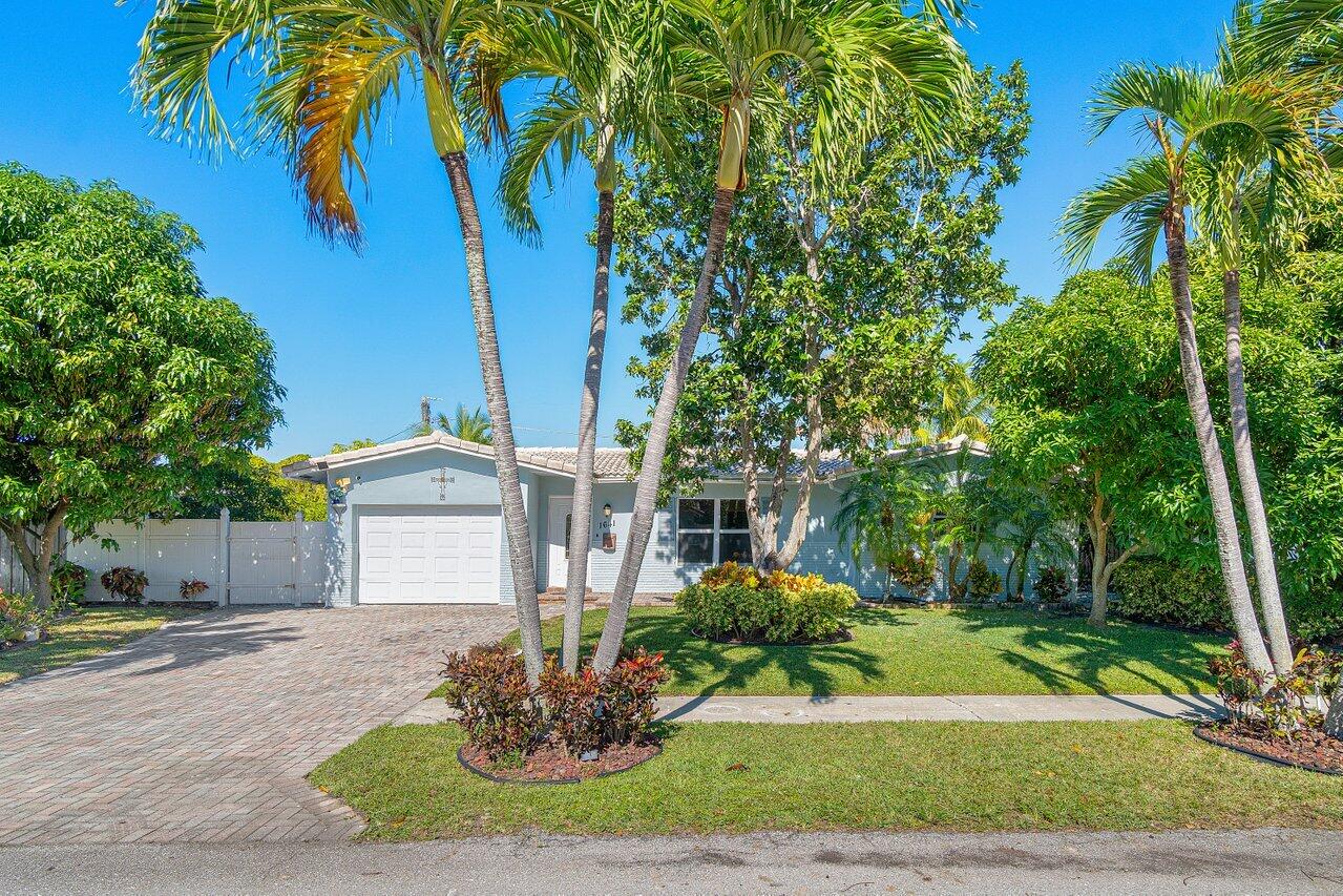 1641 Northwest 9th Street Boca Raton, FL 33486 - Photo 2 of 29 a front view of a house with a yard