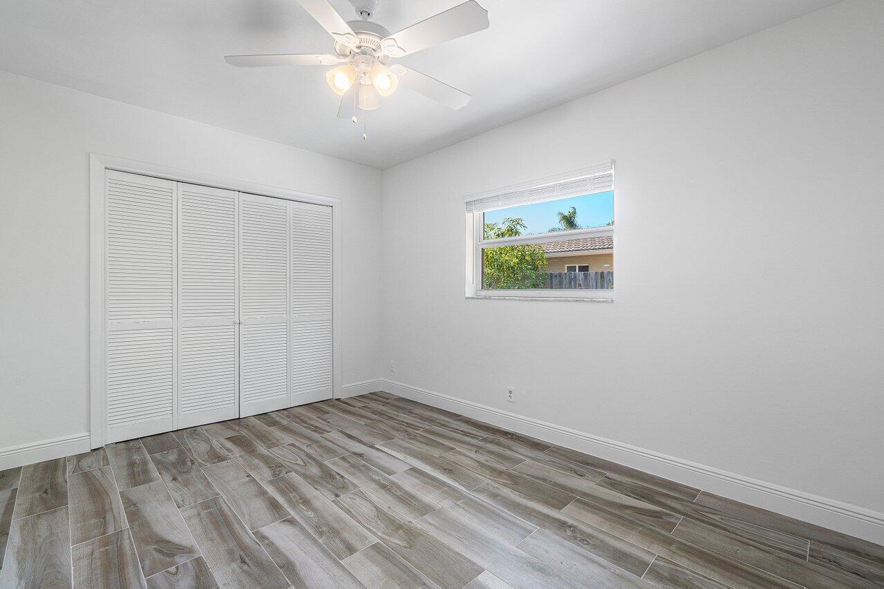 1641 Northwest 9th Street Boca Raton, FL 33486 - Photo 23 of 29 an empty room with a window and a fan