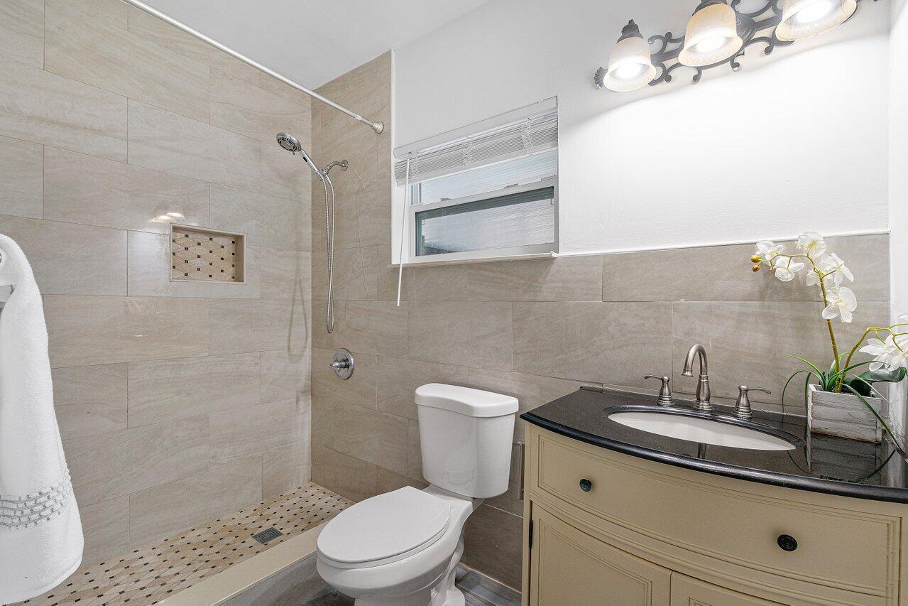 1641 Northwest 9th Street Boca Raton, FL 33486 - Photo 24 of 29 a bathroom with a sink a toilet and shower