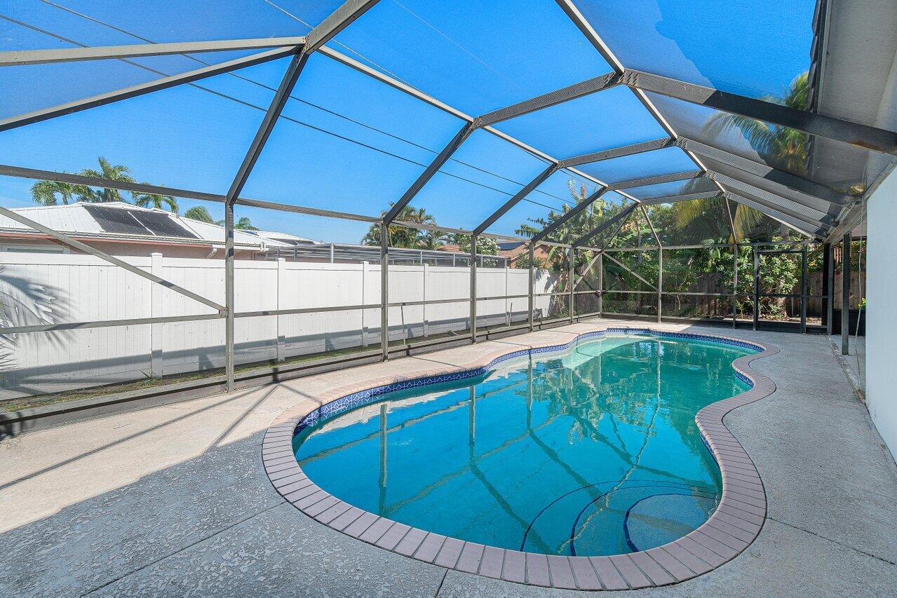 1641 Northwest 9th Street Boca Raton, FL 33486 - Photo 26 of 29 a view of a swimming pool with a patio