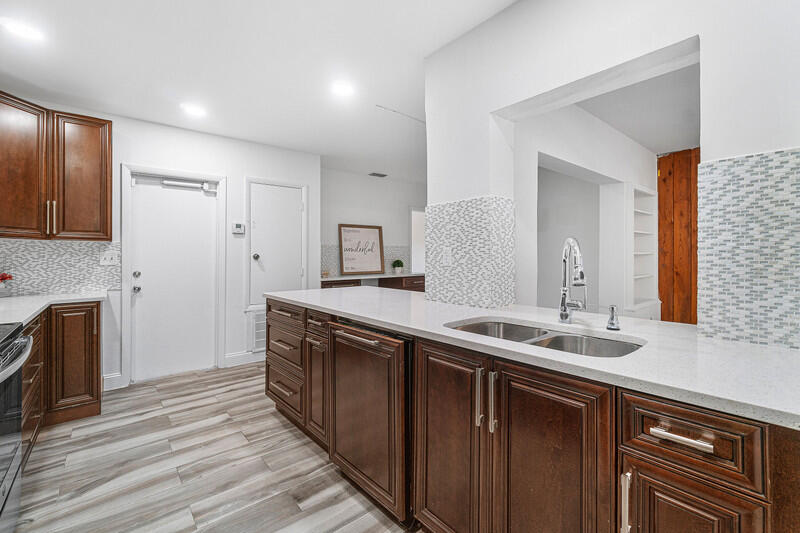 1641 Northwest 9th Street Boca Raton, FL 33486 - Photo 8 of 29 a spacious bathroom with double vanity and mirrors