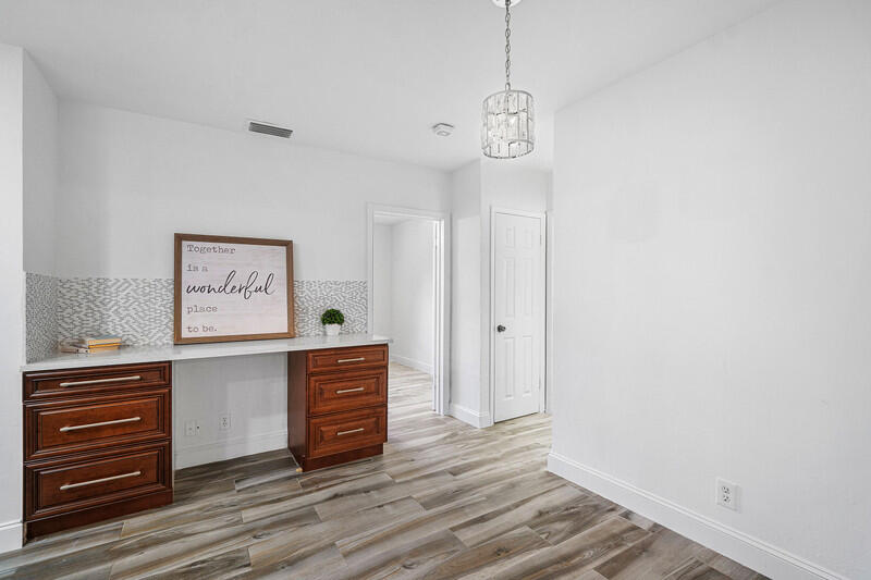 1641 Northwest 9th Street Boca Raton, FL 33486 - Photo 10 of 29 a view of a hallway with closet and wooden floor